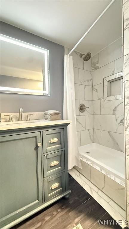 full bathroom featuring vanity, curtained shower, and wood finished floors