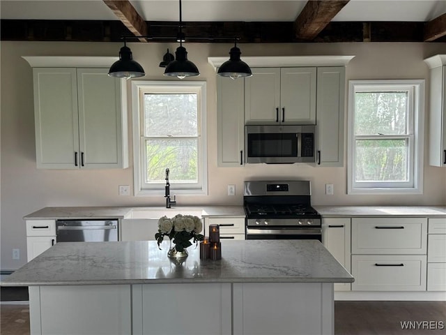 kitchen featuring appliances with stainless steel finishes, beamed ceiling, white cabinetry, and light stone countertops