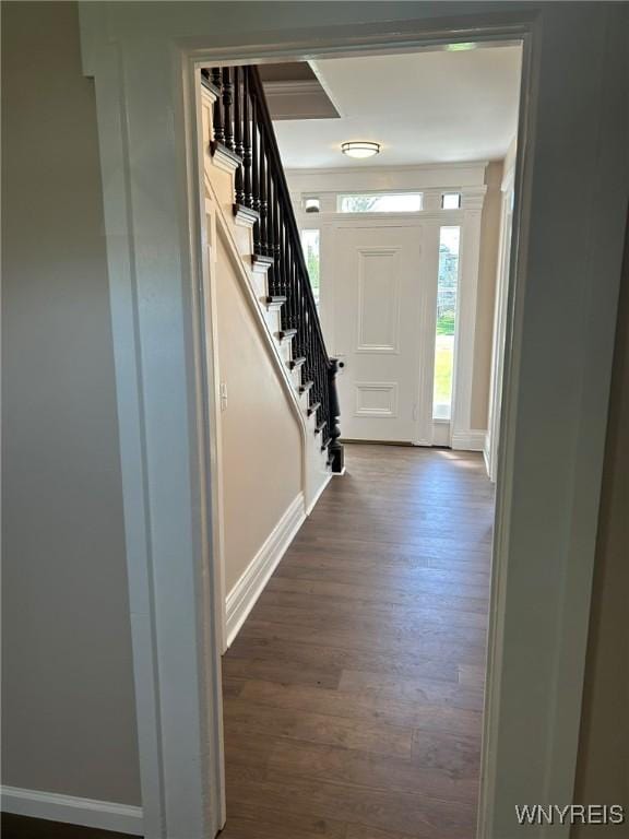 entryway featuring stairs, dark wood-style flooring, and baseboards