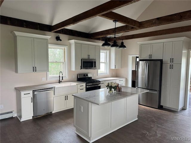kitchen with a kitchen island, appliances with stainless steel finishes, a sink, a baseboard heating unit, and dark wood-style floors