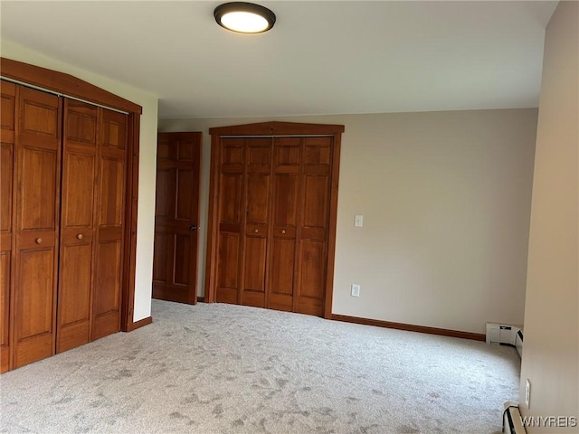 7310 Milestrip Rd, Orchard Park, NY 14127 - unfurnished bedroom with two closets, carpet floors, baseboards, and baseboard heating