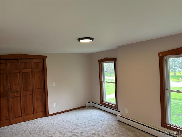 7310 Milestrip Rd, Orchard Park, NY 14127 - unfurnished bedroom featuring light colored carpet, multiple windows, baseboards, and baseboard heating