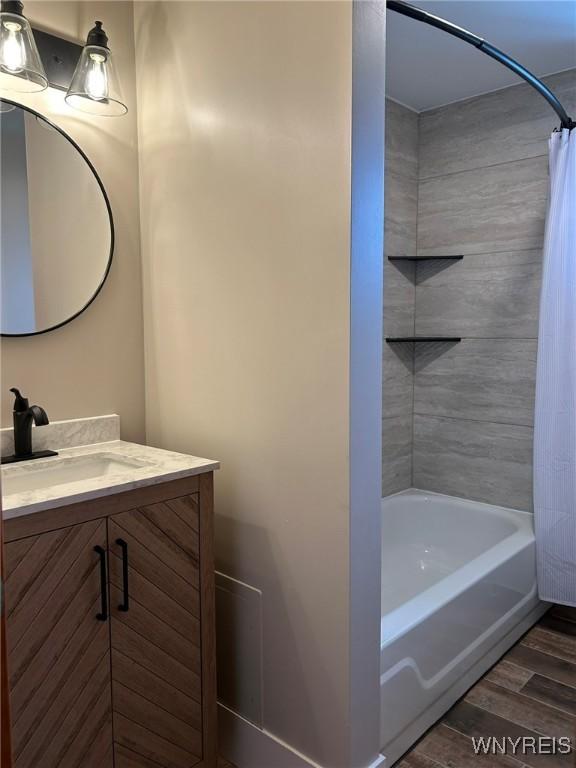 7310 Milestrip Rd, Orchard Park, NY 14127 - full bath featuring shower / bath combo with shower curtain, wood finished floors, and vanity