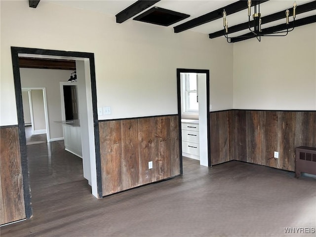 7310 Milestrip Rd, Orchard Park, NY 14127 - unfurnished room featuring radiator, beam ceiling, wood walls, and wainscoting