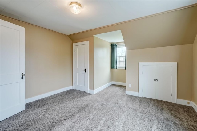 bonus room with baseboards, carpet, and vaulted ceiling