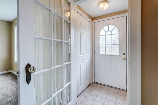 doorway to outside featuring light tile patterned floors