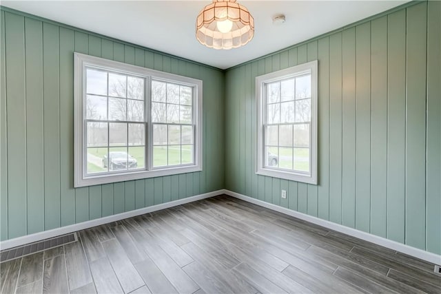 empty room featuring baseboards and wood finished floors