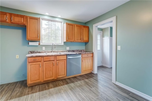 kitchen with stainless steel dishwasher, light wood-style floors, baseboards, recessed lighting, and a sink