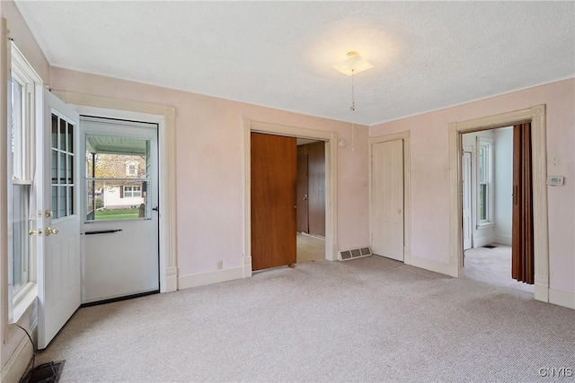 interior space with baseboards and visible vents