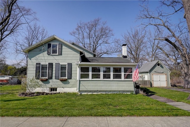 view of front of house with a garage, a front yard, and a chimney