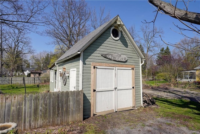 view of shed featuring fence