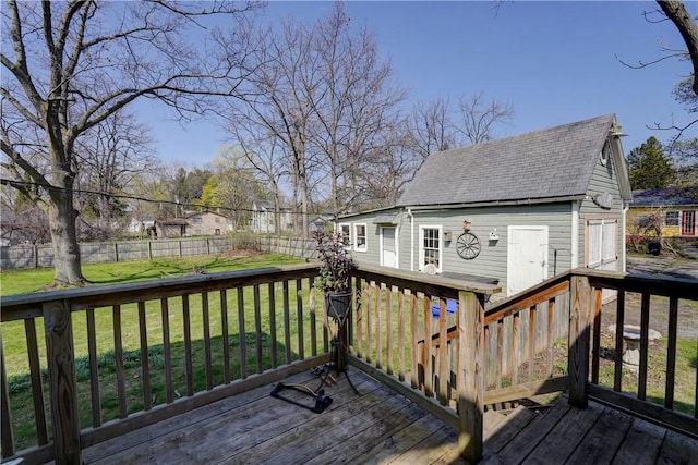 wooden terrace featuring a fenced backyard and a yard