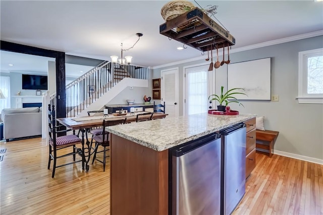 kitchen featuring baseboards, ornamental molding, light wood finished floors, and freestanding refrigerator