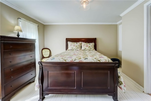 bedroom featuring crown molding and light wood-type flooring