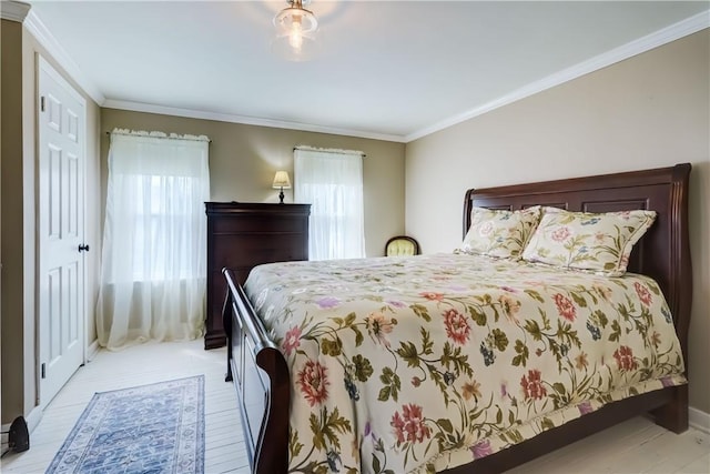 bedroom featuring crown molding and baseboards