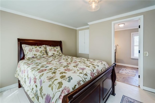 bedroom featuring light wood-style floors, baseboards, and ornamental molding
