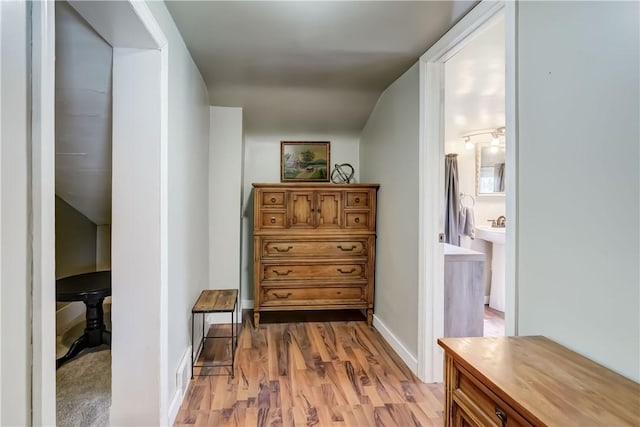 corridor featuring light wood finished floors