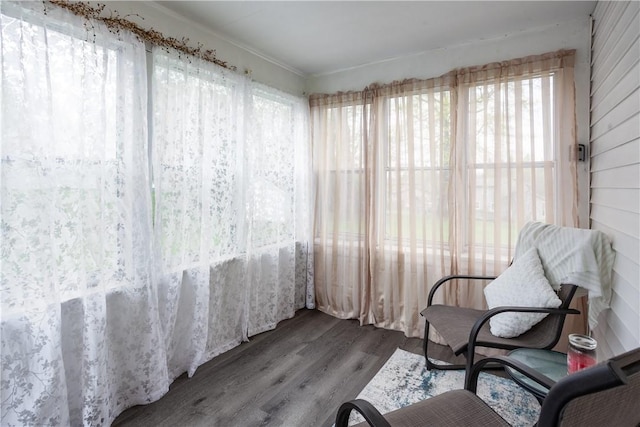 sitting room featuring crown molding, plenty of natural light, and wood finished floors