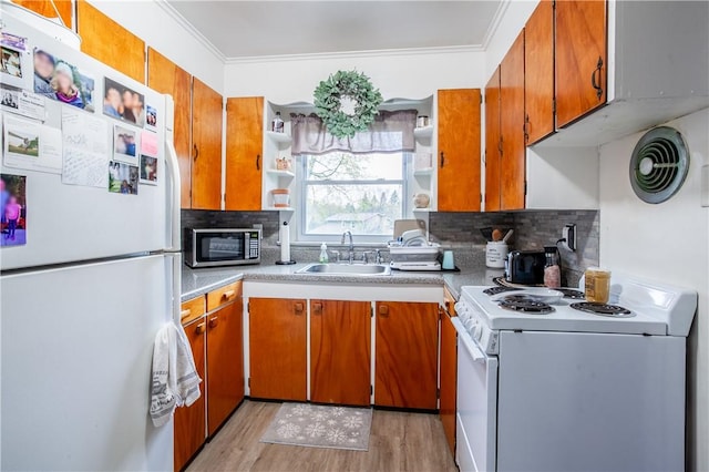kitchen featuring open shelves, a sink, white appliances, light wood-style flooring, and tasteful backsplash