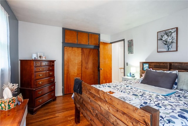 bedroom with a closet and dark wood-style floors