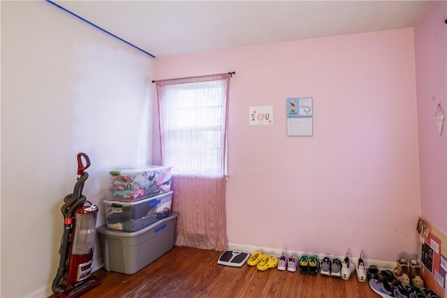 bedroom featuring baseboards and wood finished floors