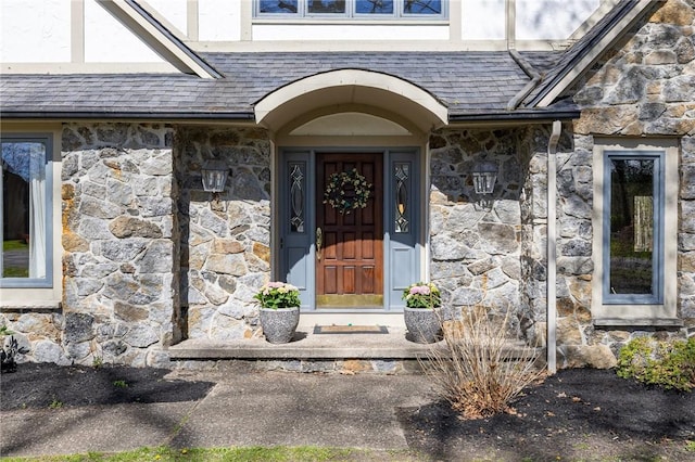 property entrance featuring stone siding