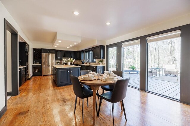 dining space with recessed lighting and light wood-type flooring