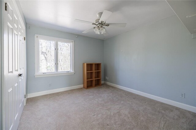 unfurnished room with baseboards, carpet, and ceiling fan