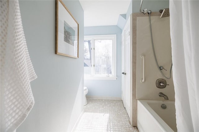 bathroom featuring toilet, tile patterned floors, and shower / bath combo with shower curtain