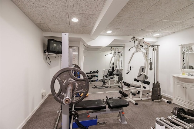 workout area with recessed lighting, baseboards, and a drop ceiling