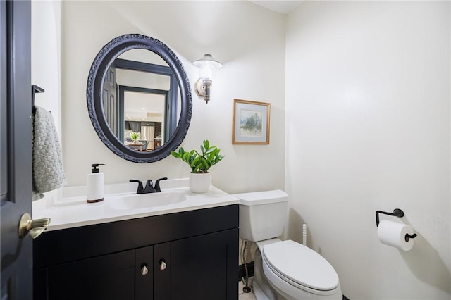 half bathroom with toilet and vanity