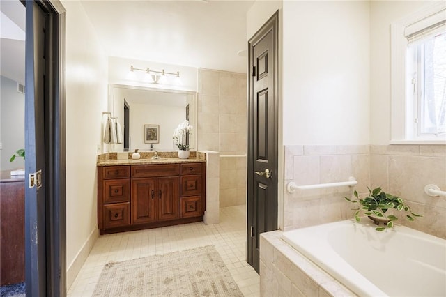 full bath featuring vanity and a bath