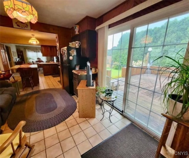 interior space with light tile patterned flooring and a healthy amount of sunlight