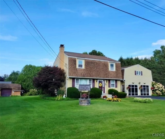 view of front of property featuring a gambrel roof, a front lawn, and a chimney