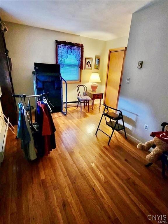 living area featuring baseboards and wood finished floors