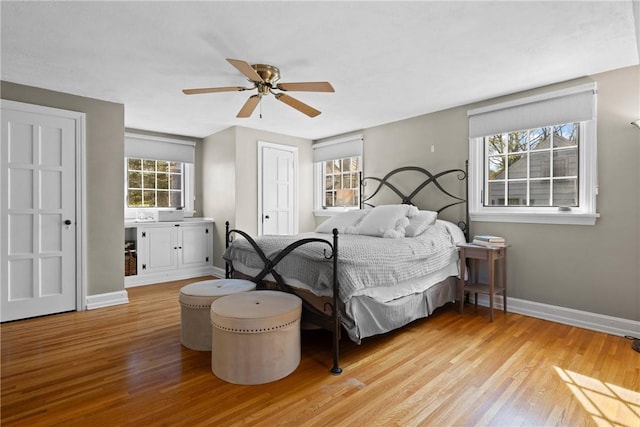 bedroom featuring baseboards, a ceiling fan, and wood finished floors