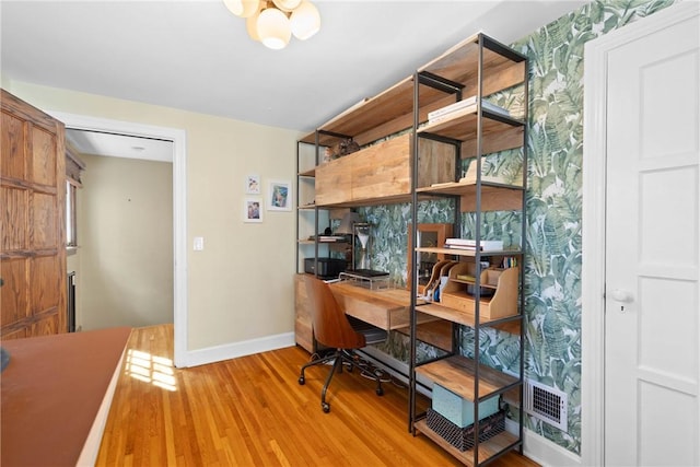home office with light wood-style floors, baseboards, and visible vents