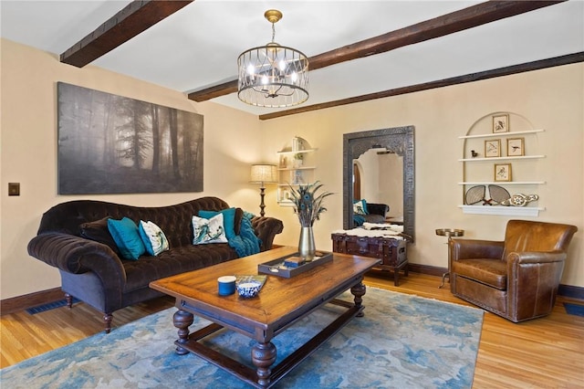 living area featuring baseboards, beamed ceiling, a notable chandelier, and wood finished floors