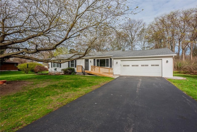 single story home featuring driveway, a front yard, and a garage