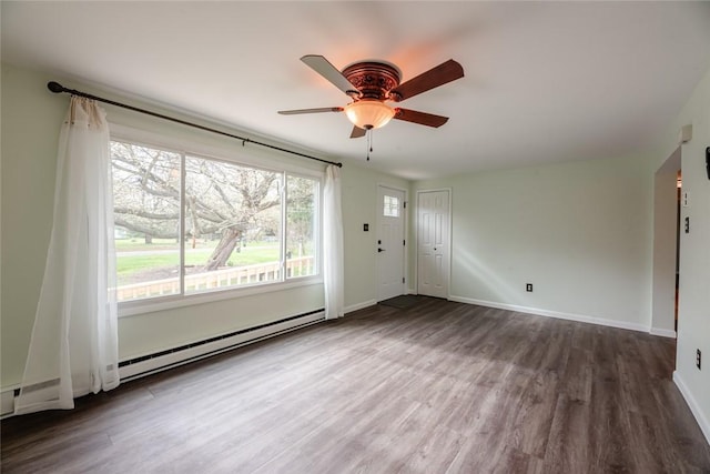unfurnished living room with a ceiling fan, baseboards, and wood finished floors