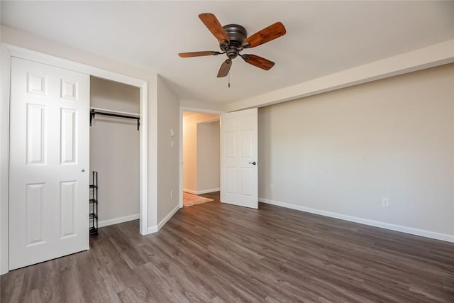 unfurnished bedroom featuring baseboards, a ceiling fan, and dark wood-style flooring