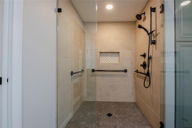 bathroom featuring recessed lighting and a shower stall