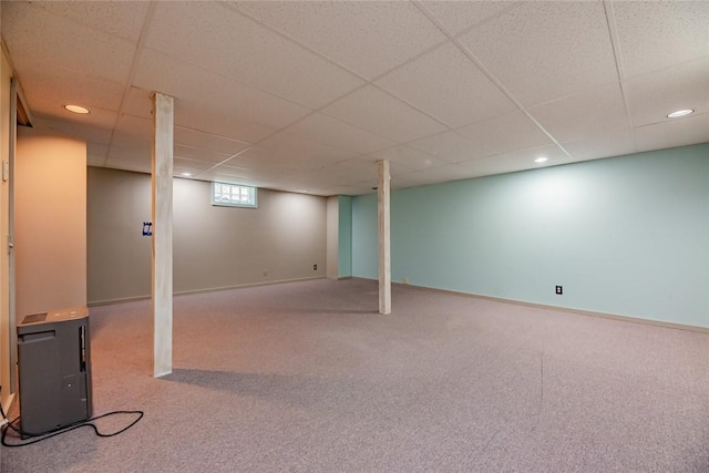 below grade area featuring recessed lighting, carpet flooring, a paneled ceiling, and baseboards