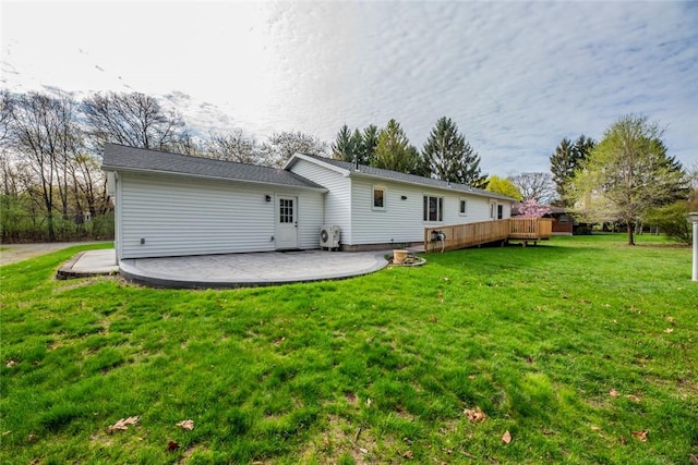 back of house with a yard, a patio area, and a deck