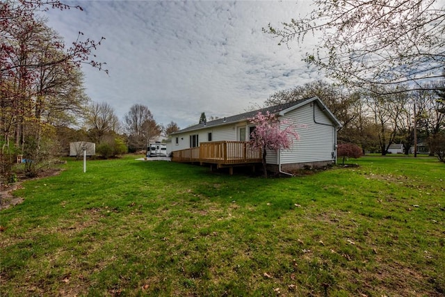 back of property featuring a yard and a deck