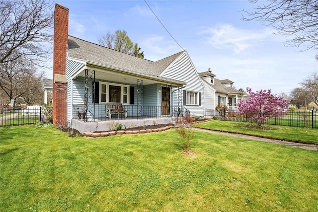 view of front of home with a porch, a front lawn, and a chimney