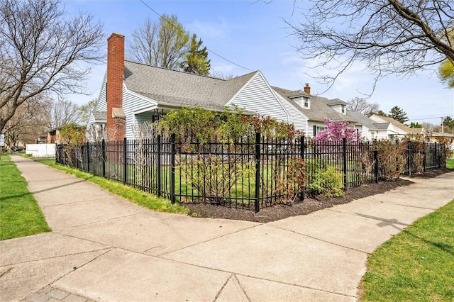 view of property exterior with a fenced front yard