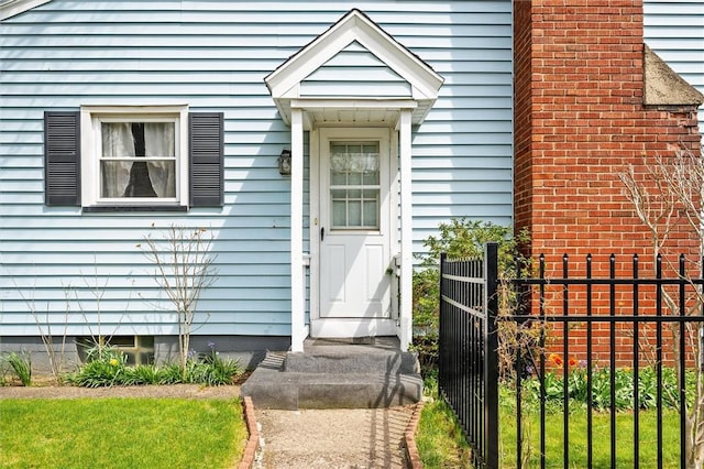 entrance to property featuring fence