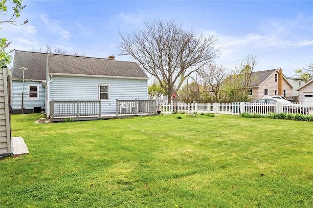 view of yard with fence and a deck