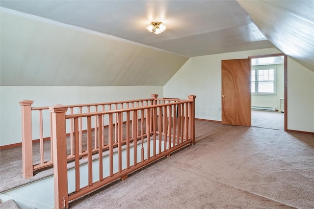 additional living space with baseboards, carpet, and vaulted ceiling